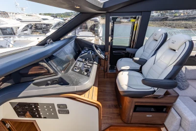 Luxurious 2023 Princess S72 yacht cockpit with modern controls and plush seating.