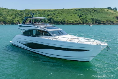 Luxury 2023 Princess S72 yacht cruising on a scenic, sunny day.