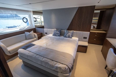 Luxurious 2023 Princess S72 yacht bedroom with elegant decor and scenic window views.