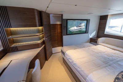 Luxurious 2023 Princess S72 yacht bedroom with modern wood accents and elegant furnishings.