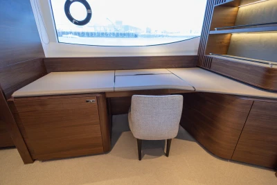 Luxurious wooden desk area on 2023 Princess S72 yacht, featuring elegant design and comfortable seating.