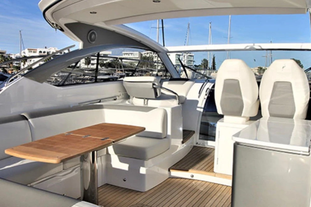 Luxurious 2017 Princess V40 yacht interior with seating and wooden table.