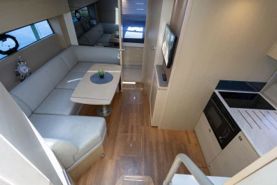 Luxurious interior of a 2017 Princess V40 yacht featuring a cozy seating area and modern kitchen.