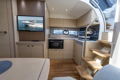 Luxurious interior of 2017 Princess V40 yacht with modern kitchen and entertainment area.