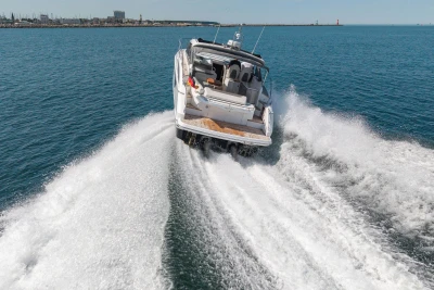 2017 Princess V40 yacht cruising swiftly on open water, leaving a foamy wake.