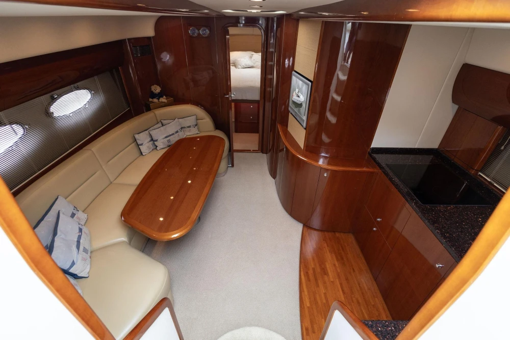 Luxurious interior of a 2006 Princess V48 yacht with elegant wood finishes.