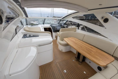 Luxurious 2006 Princess V48 yacht interior with elegant seating and wooden table.