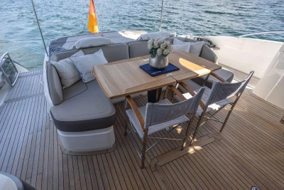 Luxurious 2014 Princess S72 yacht deck with elegant seating and dining area overlooking the ocean.