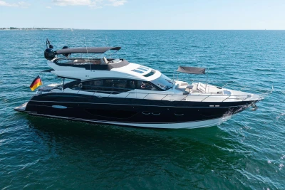 Luxurious 2014 Princess S72 yacht cruising on open sea under clear skies.