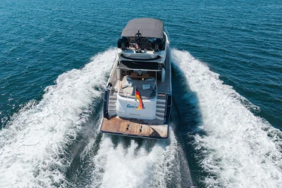 Luxury yacht Princess S72 cruising on open water, rear view, 2014 model.