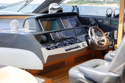 Luxurious 2014 Princess S72 yacht cockpit with advanced navigation systems and elegant steering wheel.