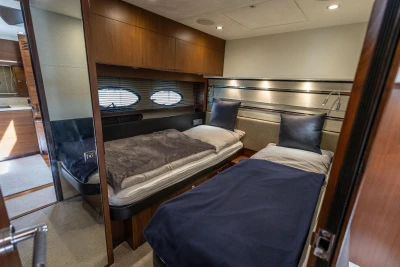 Luxurious 2014 Princess S72 yacht cabin with twin beds and elegant wood finishes.