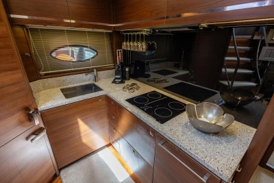 Luxurious kitchen interior of 2014 Princess S72 yacht with modern appliances and wooden cabinetry.