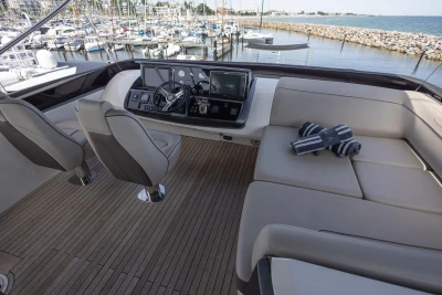 Luxurious 2014 Princess S72 yacht helm with plush seating and marina view.