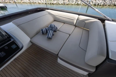 Luxurious seating area on 2014 Princess S72 yacht with striped towels, overlooking water.