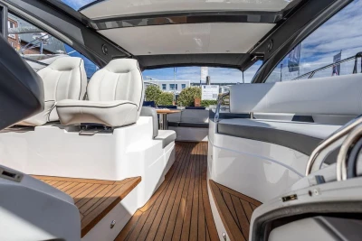2015 Princess V48 Open yacht interior with sleek seating and wooden flooring.