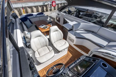 Luxurious 2015 Princess V48 Open yacht interior with plush seating and modern helm.
