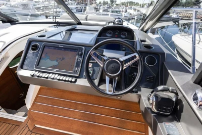 Helm of 2015 Princess V48 Open yacht with navigation system and steering wheel.