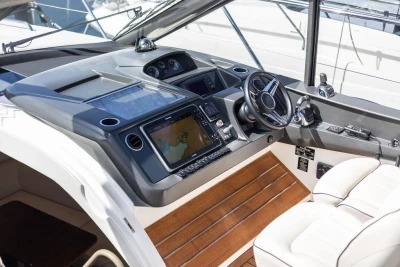 Helm of 2015 Princess V48 Open yacht with modern navigation equipment and luxurious seating.