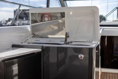 Outdoor kitchenette on 2015 Princess V48 Open yacht with sink and storage.