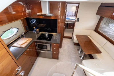 Luxurious interior of 2015 Princess V48 Open yacht with modern kitchen and seating area.