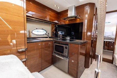 Luxurious kitchen interior of 2015 Princess V48 Open yacht with modern appliances.
