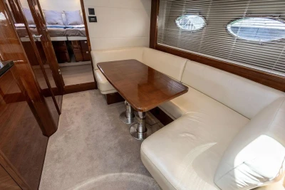 Luxurious interior of 2015 Princess V48 Open yacht with elegant seating and wooden table.