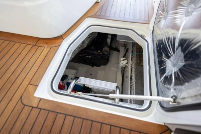 Engine compartment of 2015 Princess V48 Open yacht with wooden deck detailing.