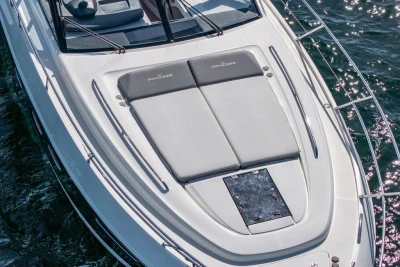 2015 Princess V48 Open yacht with sunbathing area on deck, cruising on water.