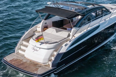 2015 Princess V48 Open yacht cruising on the ocean, featuring sleek design and spacious deck.