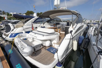 Luxury 2015 Princess V39 yacht docked at marina, featuring spacious deck and modern design.