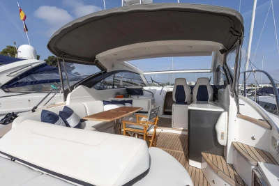 Luxury 2015 Princess V39 yacht with spacious deck and seating area in marina.