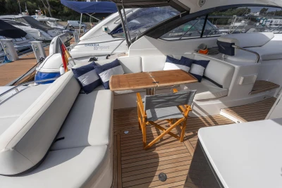 Luxurious 2015 Princess V39 yacht interior with seating, table, and nautical decor.