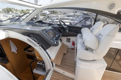 Interior view of 2015 Princess V39 yacht cockpit with modern controls and seating.