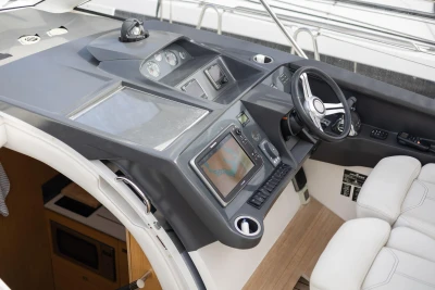 Helm of 2015 Princess V39 yacht with modern navigation controls and steering wheel.