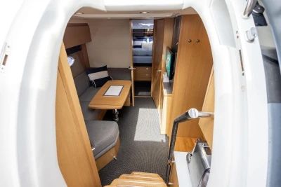 Interior of 2015 Princess V39 yacht, featuring cozy seating, wooden finishes, and modern amenities.