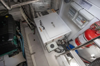 Engine room of 2015 Princess V39 yacht with generator and fire extinguisher.