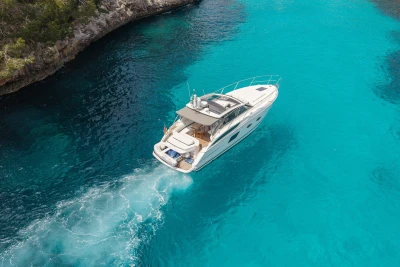 Luxury Princess V39 yacht cruising in clear turquoise waters, 2015 model.