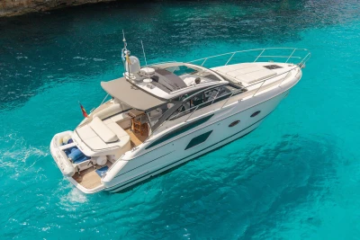 Luxury 2015 Princess V39 yacht cruising on clear turquoise waters.