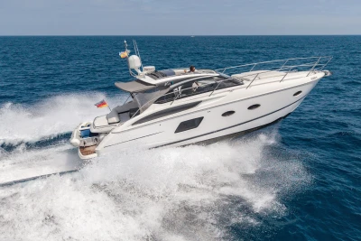 2015 Princess V39 yacht cruising on open sea, creating dynamic waves.