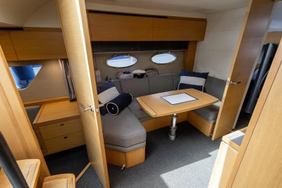 Interior of 2015 Princess V39 yacht with cozy seating and wooden table.