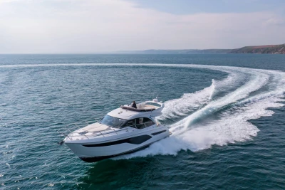2024 Princess F50 yacht cruising on open sea, creating a circular wake pattern.