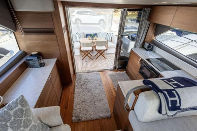 Luxurious interior of 2024 Princess F50 yacht with modern kitchen and cozy seating area.
