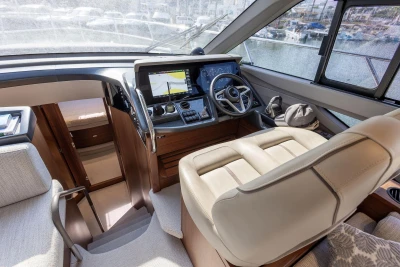 Luxurious 2024 Princess F50 yacht helm with modern navigation system and plush seating.