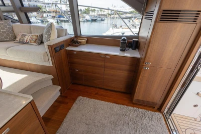 Luxurious interior of 2024 Princess F50 yacht with elegant wood cabinetry and cozy seating.