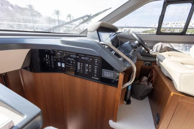 Interior helm of 2024 Princess F50 yacht with modern controls and luxurious seating.