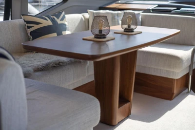 Luxurious interior of 2024 Princess F50 yacht with elegant wooden table and plush seating.