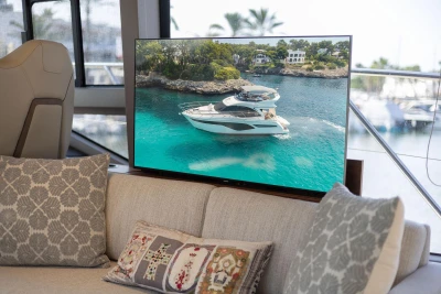 Luxurious 2024 Princess F50 yacht displayed on a screen in a stylish interior setting.