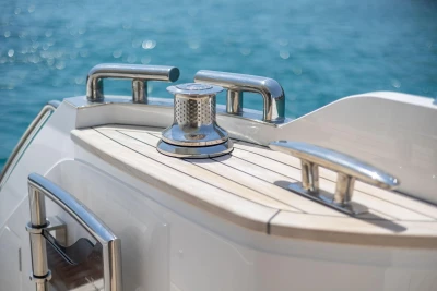 2024 Princess F50 yacht deck with polished metal fittings and ocean backdrop.
