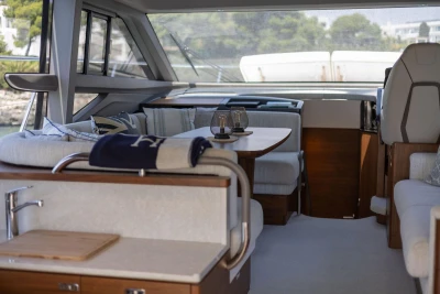 Luxurious interior of 2024 Princess F50 yacht with elegant seating and dining area.